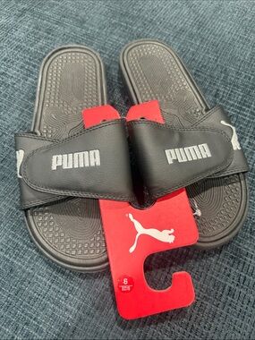Puma Black Slide Sandals with White Logo and Red Tag